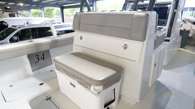 Slide: The Image of 2022 Yellowfin 34 boat interior with cushioned seating and storage area. - 35