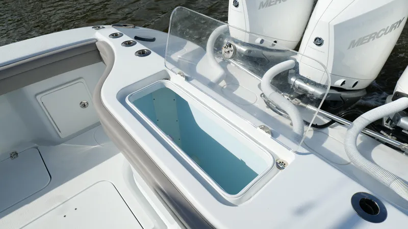 Slide: The Image of 2022 Yellowfin 34 boat with open storage compartment and Mercury engines. - 37