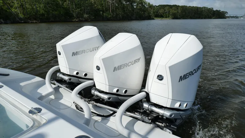 Slide: The Image of 2022 Yellowfin 34 boat with triple Mercury outboard engines on a calm river. - 38