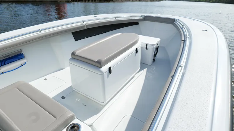 Slide: The Image of 2022 Yellowfin 34 boat interior with seating and storage on calm water. - 41