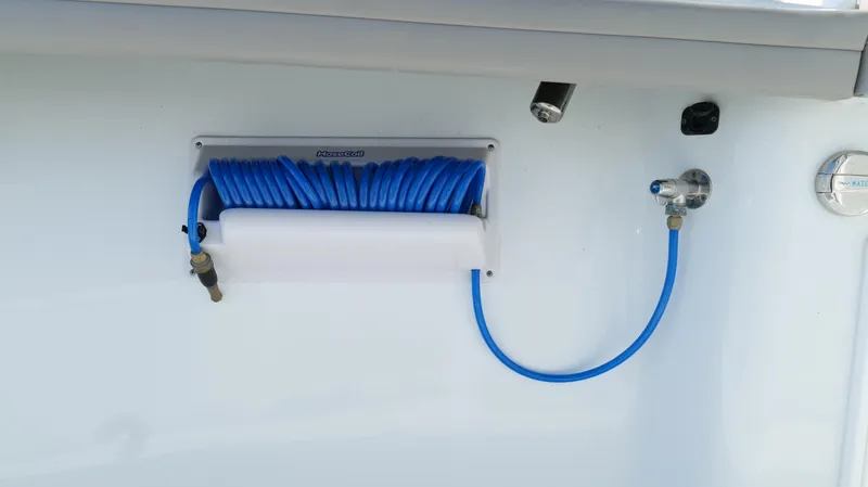 Slide: The Image of Blue coiled hose on 2022 Yellowfin 34 boat, mounted on white surface. - 43