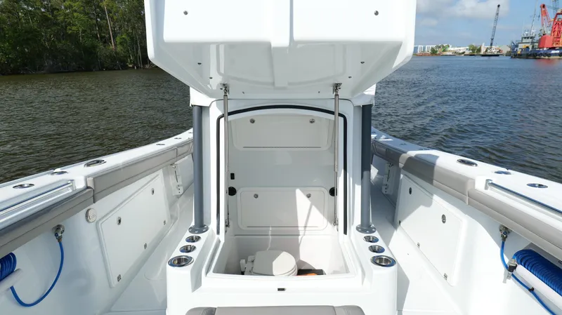 Slide: The Image of 2022 Yellowfin 34 boat interior with open storage compartment on calm water. - 46