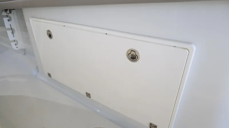 Slide: The Image of Storage compartment on a 2022 Yellowfin 34 boat, featuring secure latches. - 49