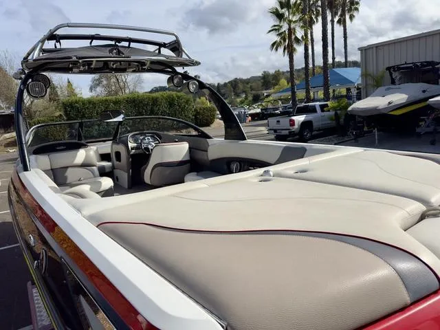 Slide: The Image of 2006 Malibu 247 LSV boat with spacious seating and sleek design in a sunny outdoor setting. - 10