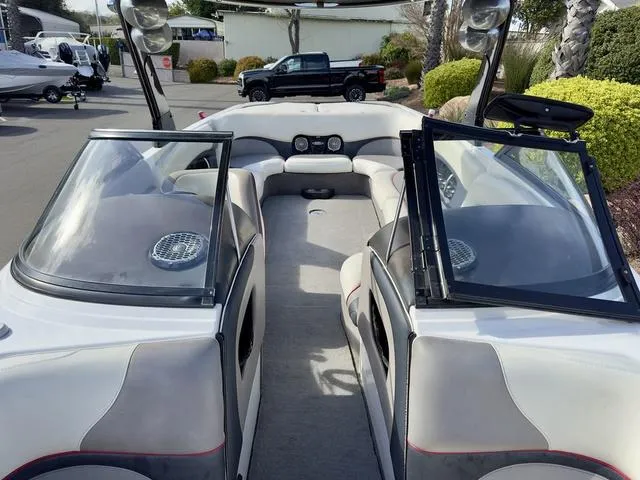 Slide: The Image of 2006 Malibu 247 LSV boat interior with open windshield and seating area. - 17