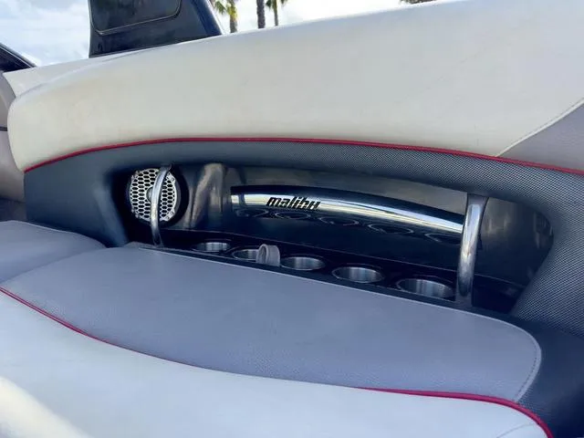 Slide: The Image of 2006 Malibu 247 LSV boat interior with cup holders and speaker. - 20