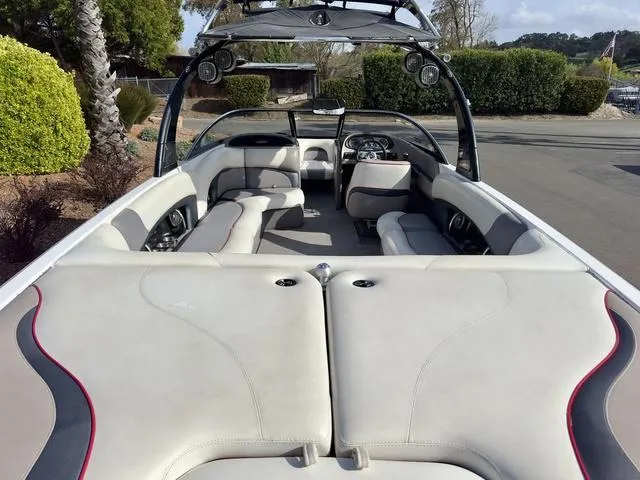 Slide: The Image of 2006 Malibu 247 LSV boat interior with spacious seating and sleek design. - 9