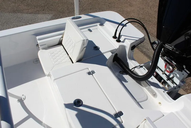 Slide: The Image of 2025 Blazer 2220 Fisherman boat interior with cushioned seating and engine controls. - 13