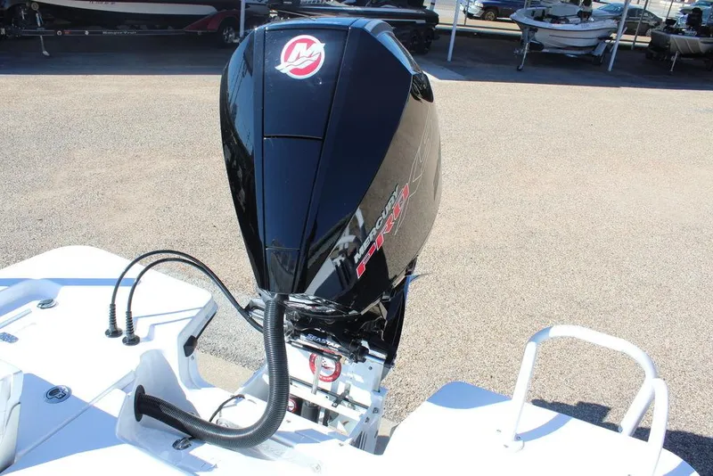 Slide: The Image of 2025 Blazer 2220 Fisherman boat with powerful outboard motor in a marina setting. - 14