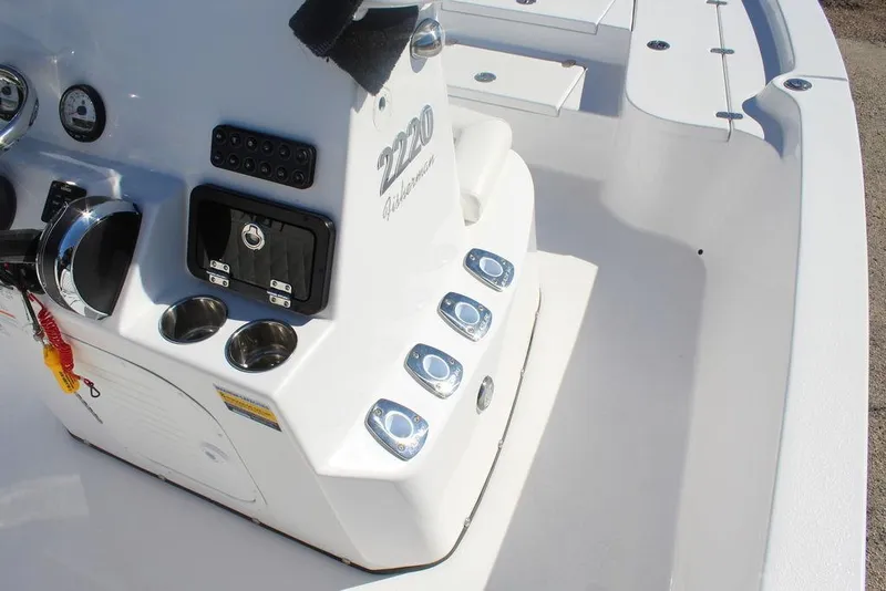 Slide: The Image of 2025 Blazer 2220 Fisherman boat console with controls and cup holders. - 16