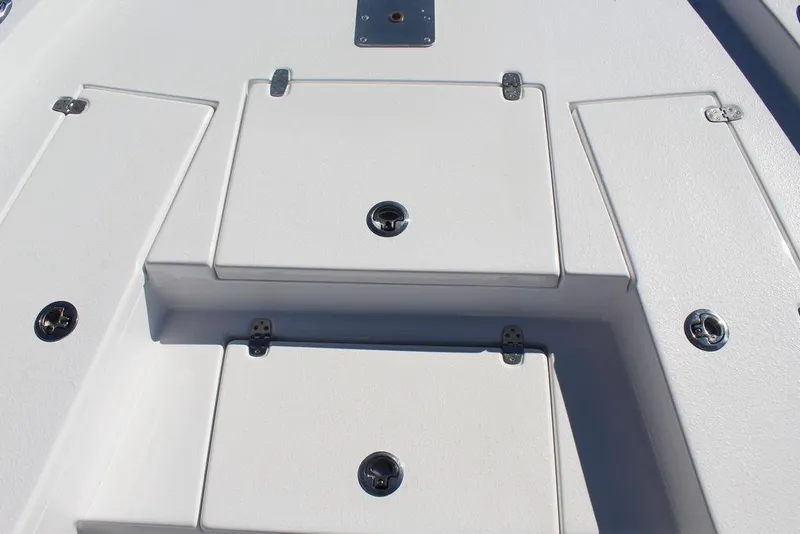 Slide: The Image of 2025 Blazer 2220 Fisherman boat deck with storage compartments and latches. - 19