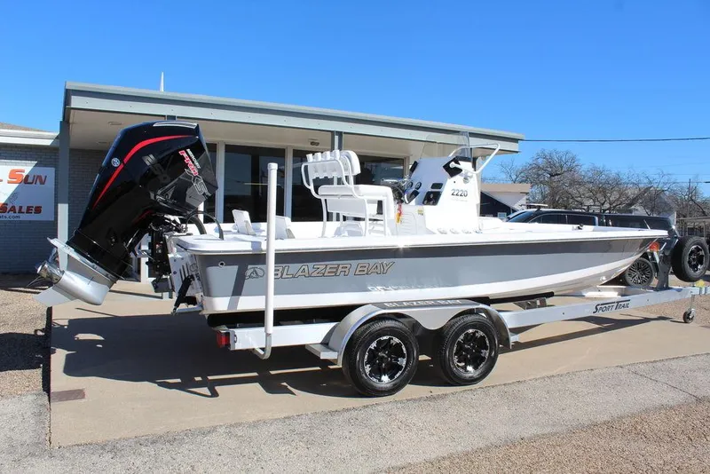 Slide: The Image of 2025 Blazer 2220 Fisherman boat on trailer, parked outside a building. - 5