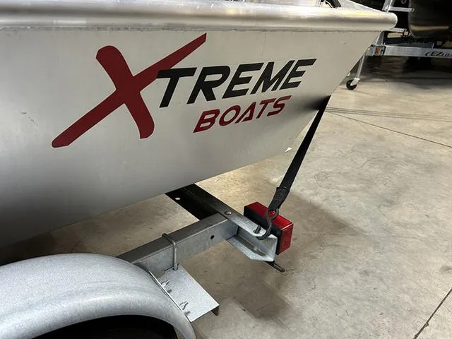 Slide: The Image of 2021 XTREME BOATS River Skiff 15452 SS on trailer, showcasing brand logo. - 8