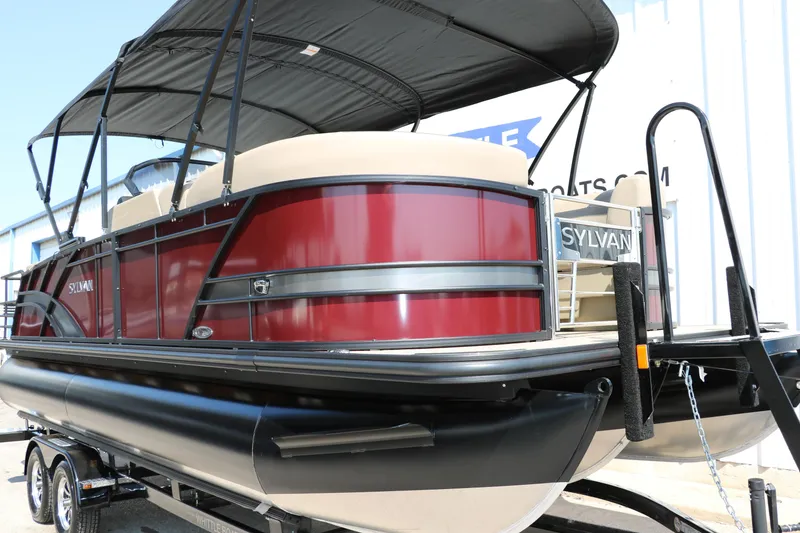Slide: The Image of 2025 Sylvan L3 CLZ DH pontoon boat with red exterior and black canopy. - 12