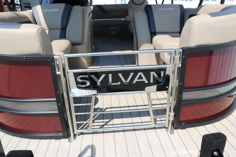 Slide: The Image of 2025 Sylvan L3 CLZ DH pontoon boat interior with beige seating and branded gate. - 17