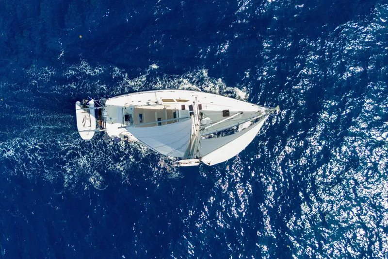 Slide: The Image of Aerial view of 2009 Hylas 54 sailboat navigating through deep blue ocean waters. - 11