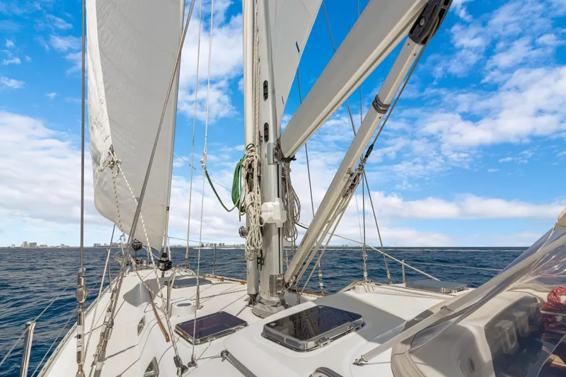 Slide: The Image of Sailing on a 2009 Hylas 54 yacht under clear blue skies. - 16