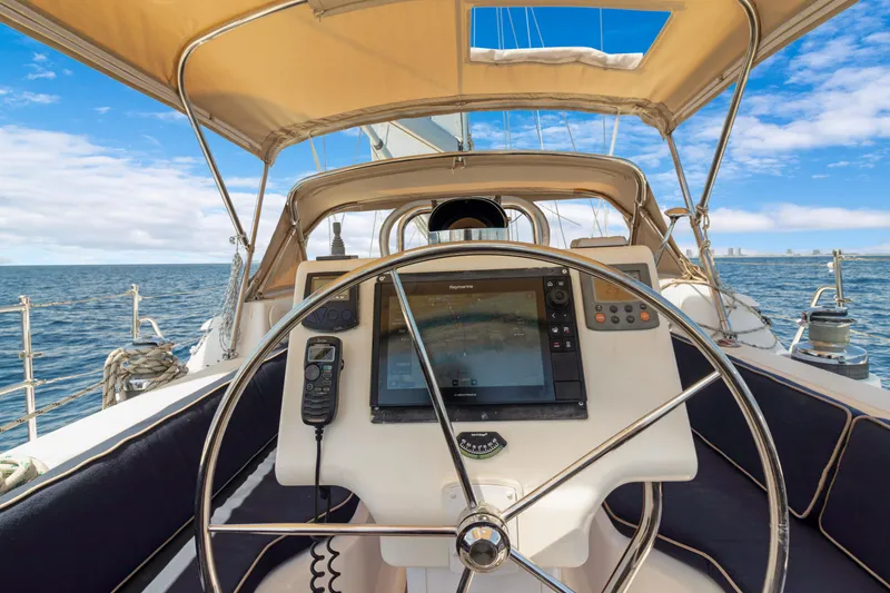 Slide: The Image of Cockpit view of 2009 Hylas 54 sailboat with navigation equipment and ocean backdrop. - 27