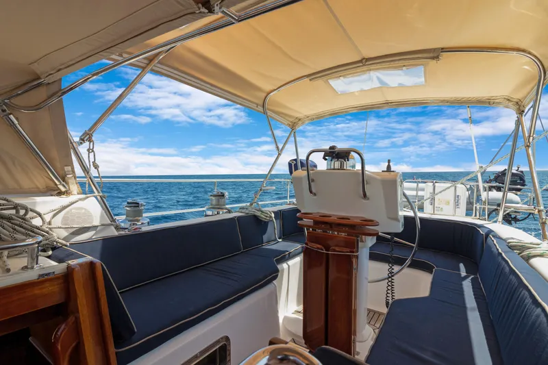 Slide: The Image of 2009 Hylas 54 yacht cockpit with blue seating, ocean view, and sunny sky. - 30