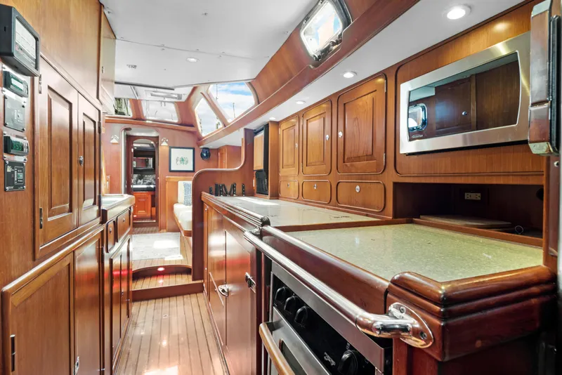 Slide: The Image of Luxurious 2009 Hylas 54 yacht interior with elegant wood cabinetry and modern appliances. - 41