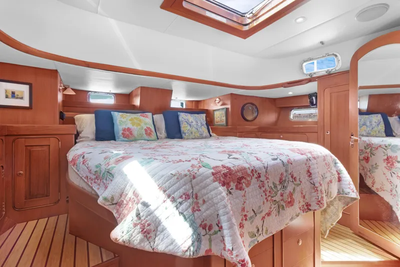 Slide: The Image of Luxurious cabin interior of 2009 Hylas 54 yacht with floral bedding and wood finish. - 42
