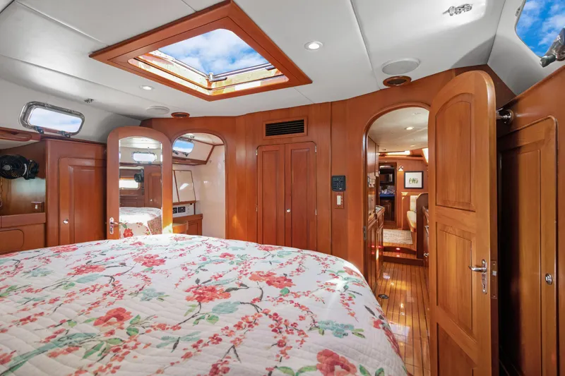 Slide: The Image of Luxurious 2009 Hylas 54 yacht interior with floral bedding and wooden cabinetry. - 44
