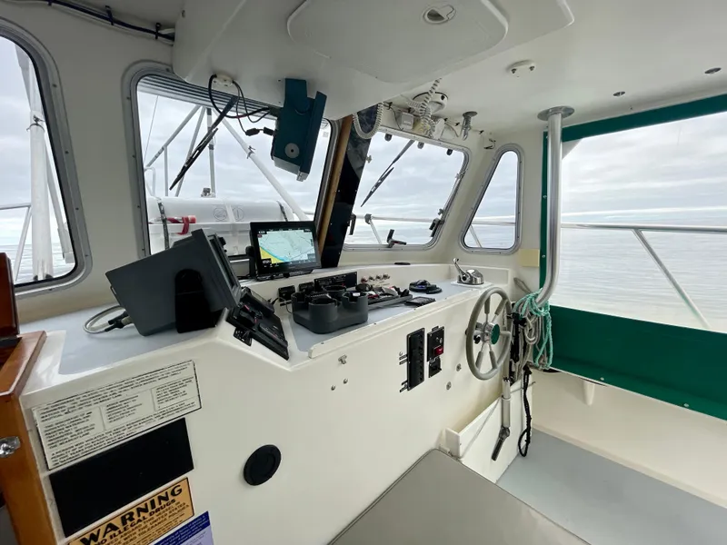 Slide: The Image of Interior of a 2004 Beal 34 boat cockpit with navigation equipment and steering wheel. - 10