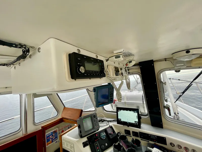 Slide: The Image of Interior of a 2004 Beal 34 boat cockpit with navigation equipment and controls. - 13