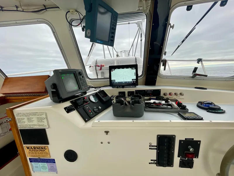 Slide: The Image of Control panel of a 2004 Beal 34 boat with navigation equipment and sea view. - 14