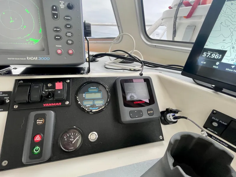 Slide: The Image of Boat dashboard with radar, Yanmar controls, and navigation screens on a 2004 Beal 34. - 20