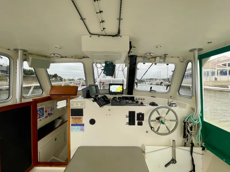 Slide: The Image of Interior of a 2004 Beal 34 boat cockpit with navigation equipment and steering wheel. - 23