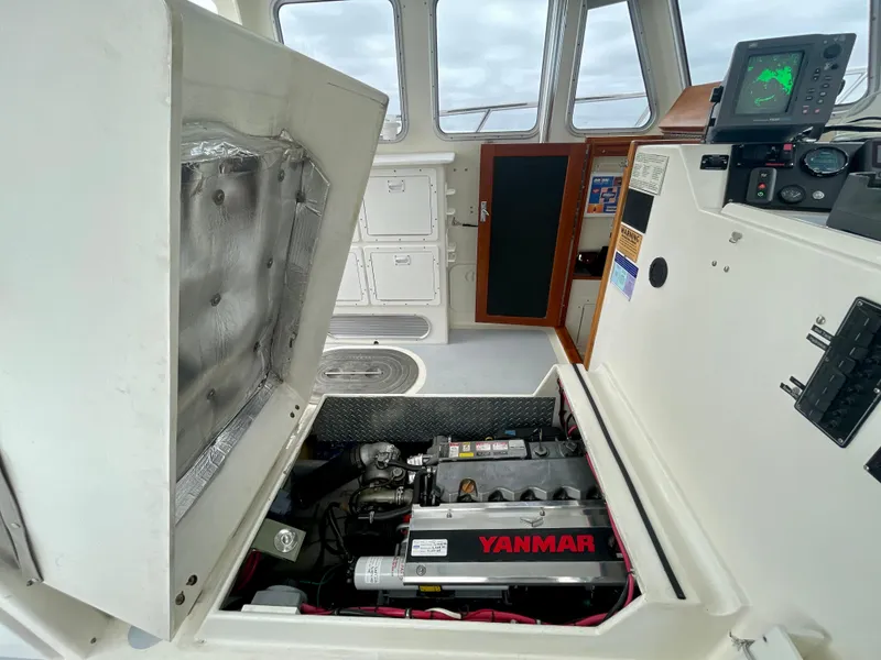 Slide: The Image of Engine compartment of a 2004 Beal 34 boat with Yanmar engine visible. - 27