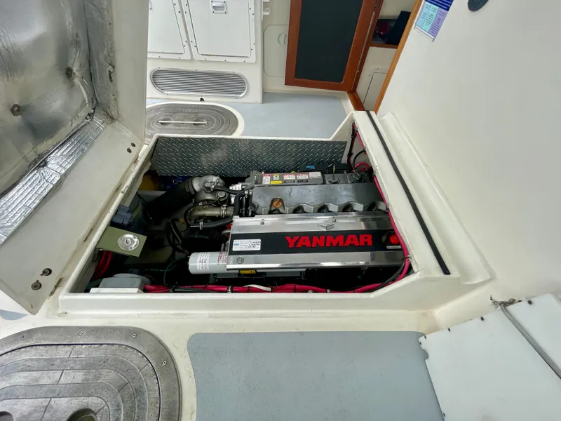 Slide: The Image of Engine compartment of a 2004 Beal 34 boat featuring a Yanmar engine. - 28