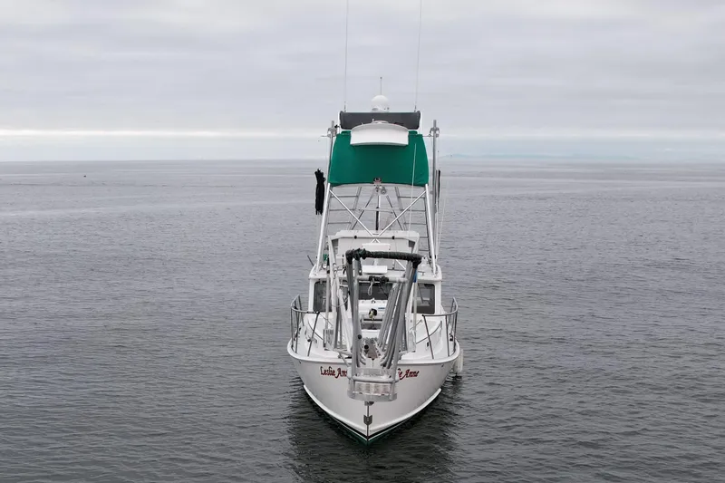 Slide: The Image of Front view of a 2004 Beal 34 boat on calm waters under a cloudy sky. - 3