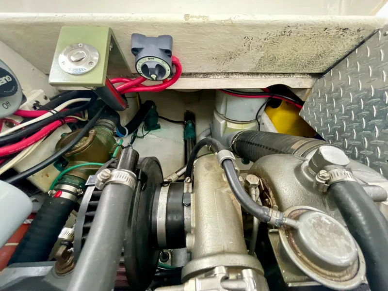 Slide: The Image of Engine compartment of a 2004 Beal 34 boat, featuring various mechanical components and wiring. - 30