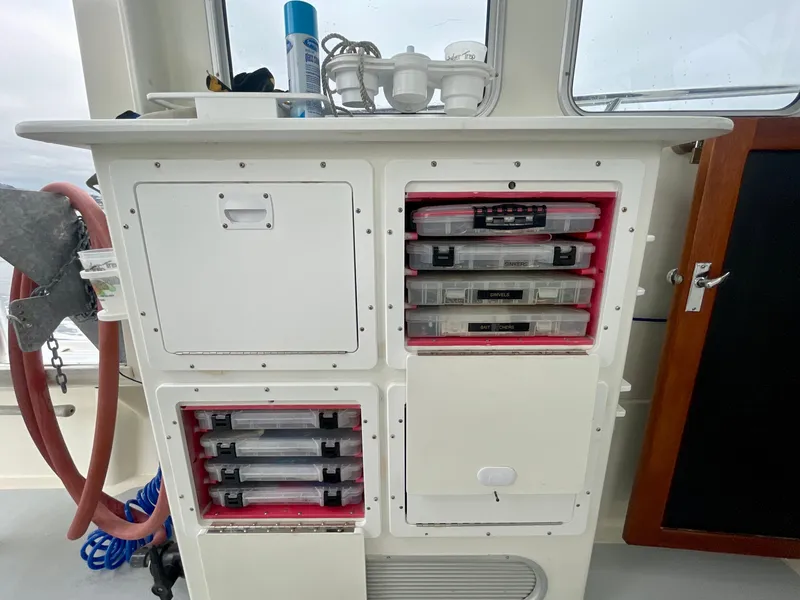 Slide: The Image of Cabinet with organized storage boxes on a 2004 Beal 34 boat. - 31