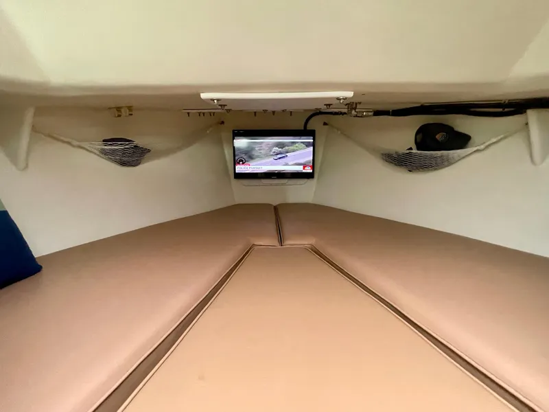 Slide: The Image of Interior cabin of a 2004 Beal 34 boat with a TV and beige cushions. - 37