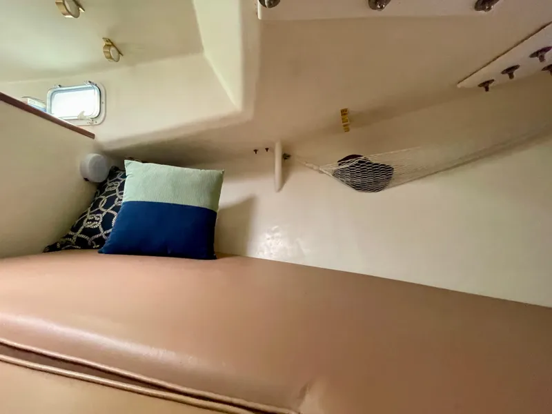 Slide: The Image of Cozy cabin interior of a 2004 Beal 34 boat with cushions and storage net. - 38