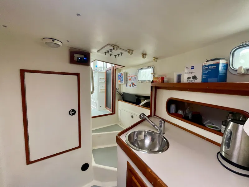 Slide: The Image of Interior of 2004 Beal 34 boat with kitchenette, sink, and storage. - 44