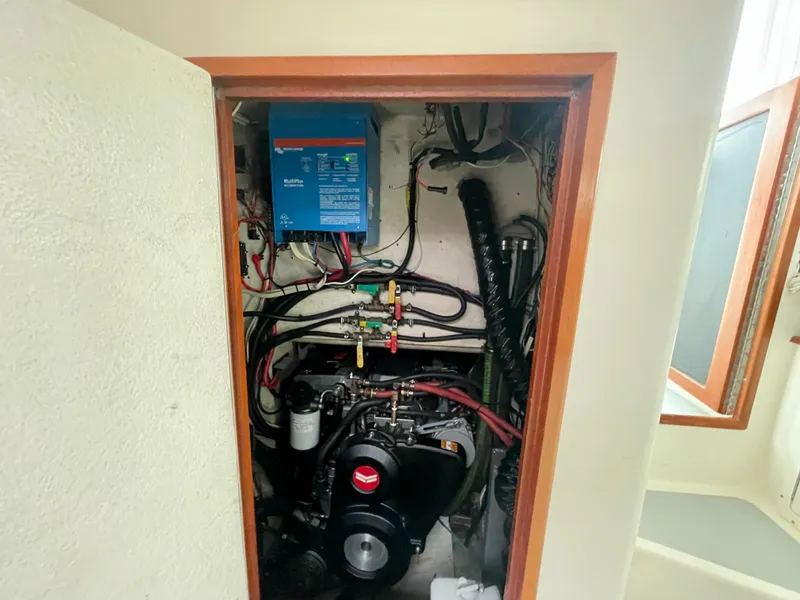 Slide: The Image of Engine compartment of a 2004 Beal 34 boat, showing wiring and mechanical components. - 45