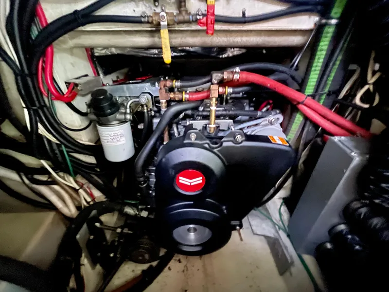 Slide: The Image of Engine compartment of a 2004 Beal 34 boat, featuring various cables and components. - 46