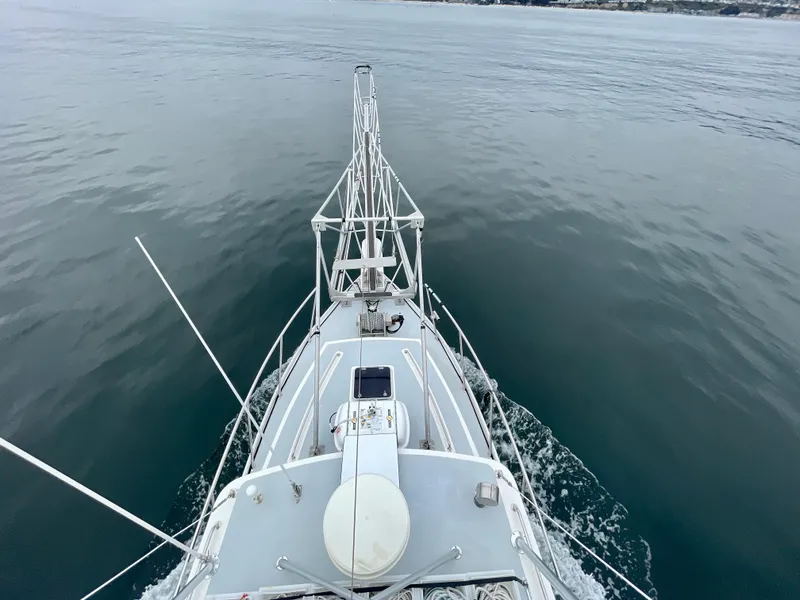 Slide: The Image of Bow view of a 2004 Beal 34 boat navigating calm waters. - 49