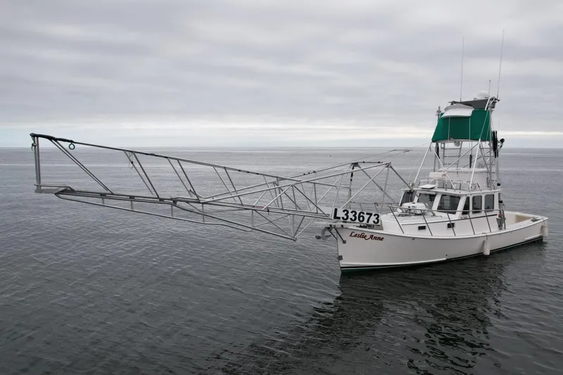 Slide: The Image of 2004 Beal 34 boat with extended rigging on calm water under cloudy sky. - 5