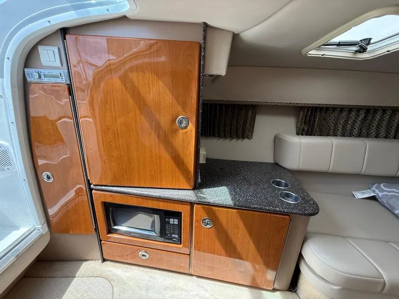 Slide: The Image of 2004 Formula 330 Sun Sport cabin interior with wood cabinetry and microwave. - 11