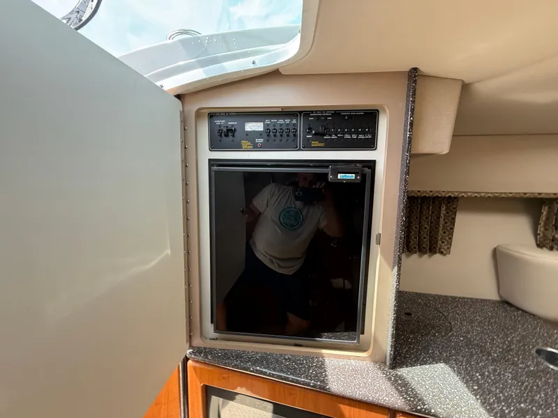 Slide: The Image of 2004 Formula 330 Sun Sport cabin interior with compact refrigerator and control panel. - 16