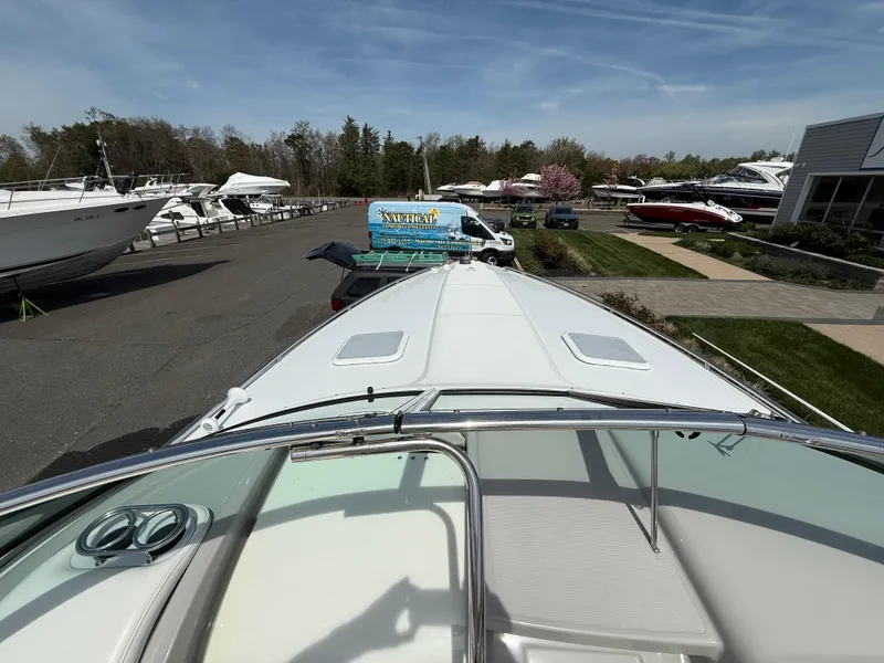 Slide: The Image of 2004 Formula 330 Sun Sport boat docked at a marina with other vessels. - 17