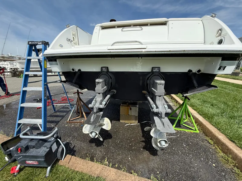 Slide: The Image of 2004 Formula 330 Sun Sport boat on stands, undergoing maintenance with tools and ladder nearby. - 18