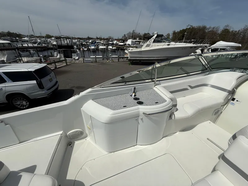 Slide: The Image of 2004 Formula 330 Sun Sport boat interior with docked yachts in the background. - 6