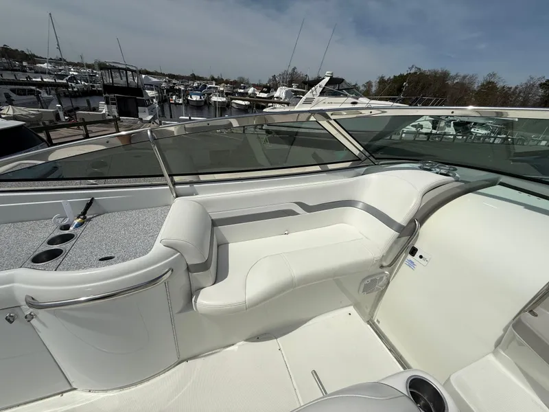 Slide: The Image of 2004 Formula 330 Sun Sport boat interior with white seating at marina. - 7