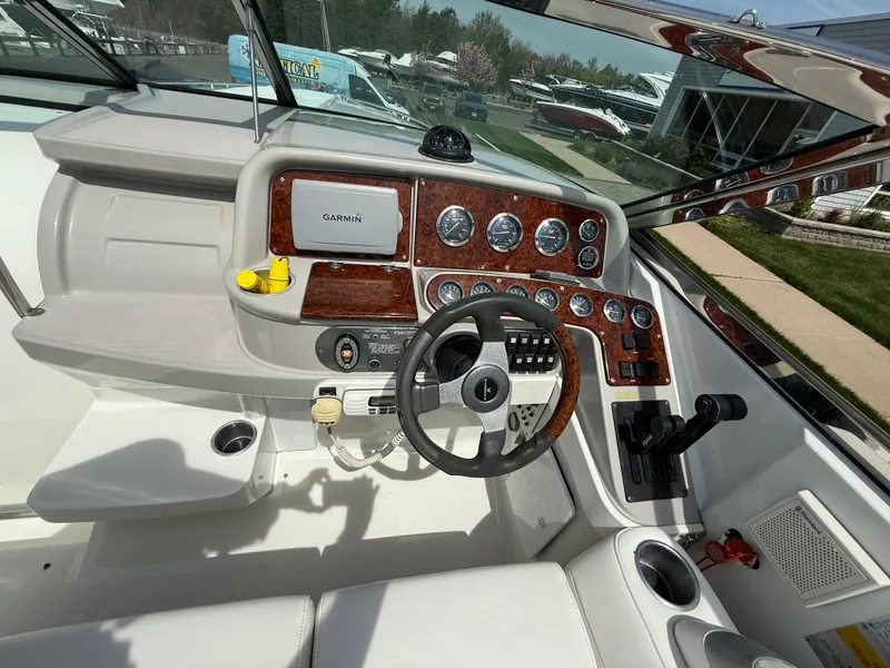 Slide: The Image of 2004 Formula 330 Sun Sport boat dashboard with Garmin navigation and wood accents. - 9